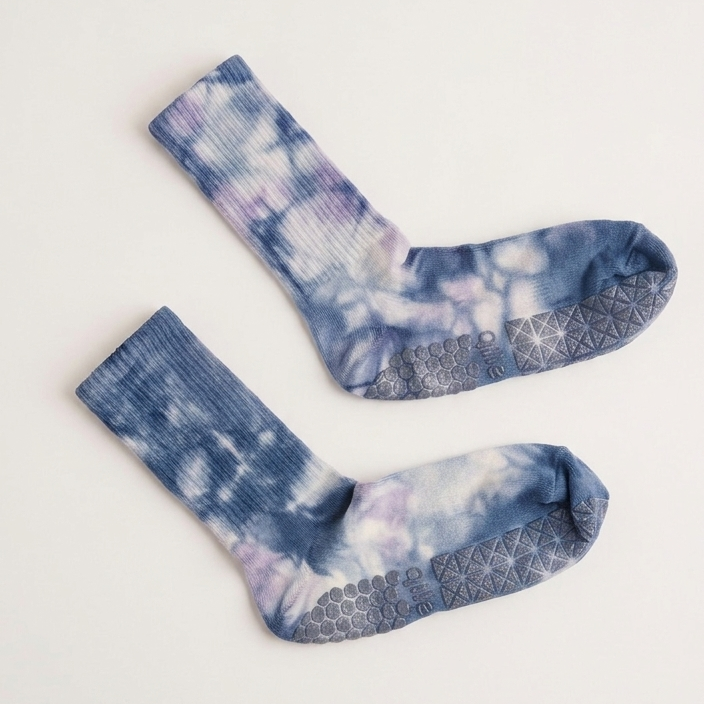 Muted sky blue tie-dye Pilates grip socks with crew length, non-slip soles, and supportive studio-ready design for barre, yoga, and workouts.