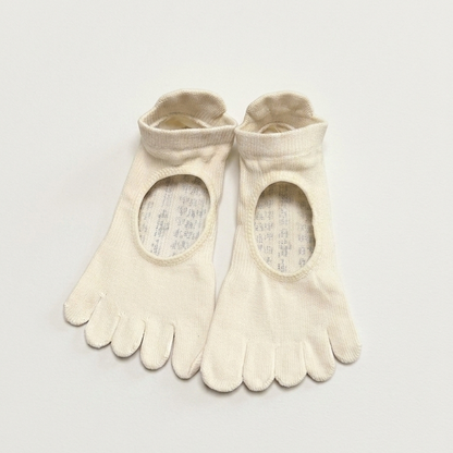 ARCHE cream five-toe grip socks with a minimalist open-top cutout design, shown flat on a light neutral background for Pilates, barre, yoga, dance and studio workouts. 