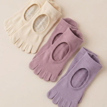 Cream, dusty mauve and lavender ARCHE five-toe non-slip grip socks for Pilates, yoga, barre and studio workouts.