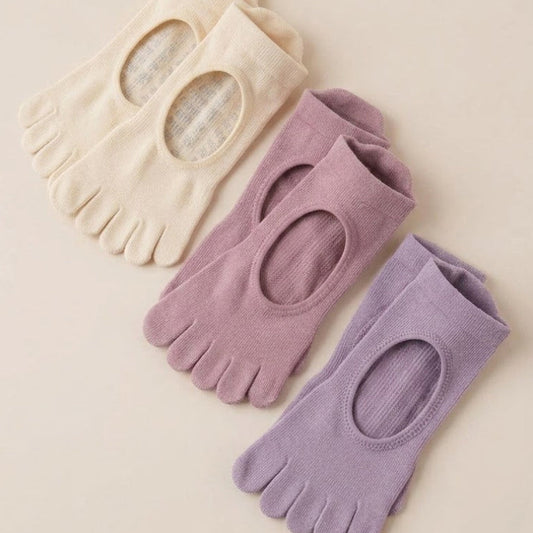 Cream, dusty mauve and lavender ARCHE five-toe non-slip grip socks for Pilates, yoga, barre and studio workouts.