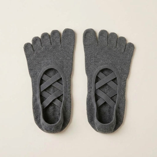 Graphite grey ballet-inspired five-toe grip socks by ARCHE for Pilates, yoga and studio workouts, featuring secure criss-cross straps and non-slip soles.
