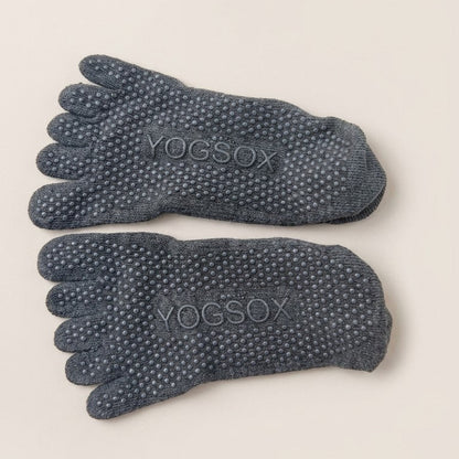 Bottom view of ARCHE graphite grey ballet-inspired five-toe grip socks featuring full-sole non-slip traction for Pilates, yoga, barre and studio workouts.