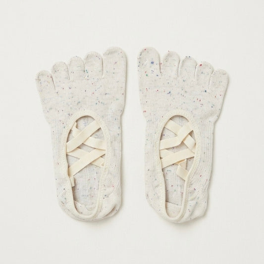 Ivory Cream speckled five-toe Pilates grip socks by ARCHE with ballet-inspired crisscross straps for reformer Pilates and studio workouts.