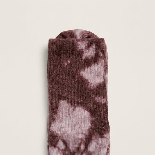 Close-up of dusty mauve boho tie-dye Pilates grip socks with ribbed crew construction and soft mauve plum studio style.