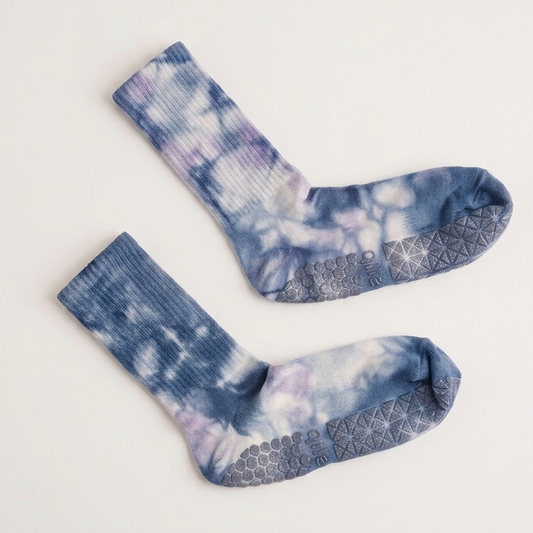 Muted sky blue tie-dye Pilates grip socks with crew length, non-slip soles, and supportive studio-ready design for barre, yoga, and workouts.